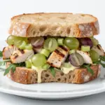creamy grilled chicken salad sandwich with grapes - featured image